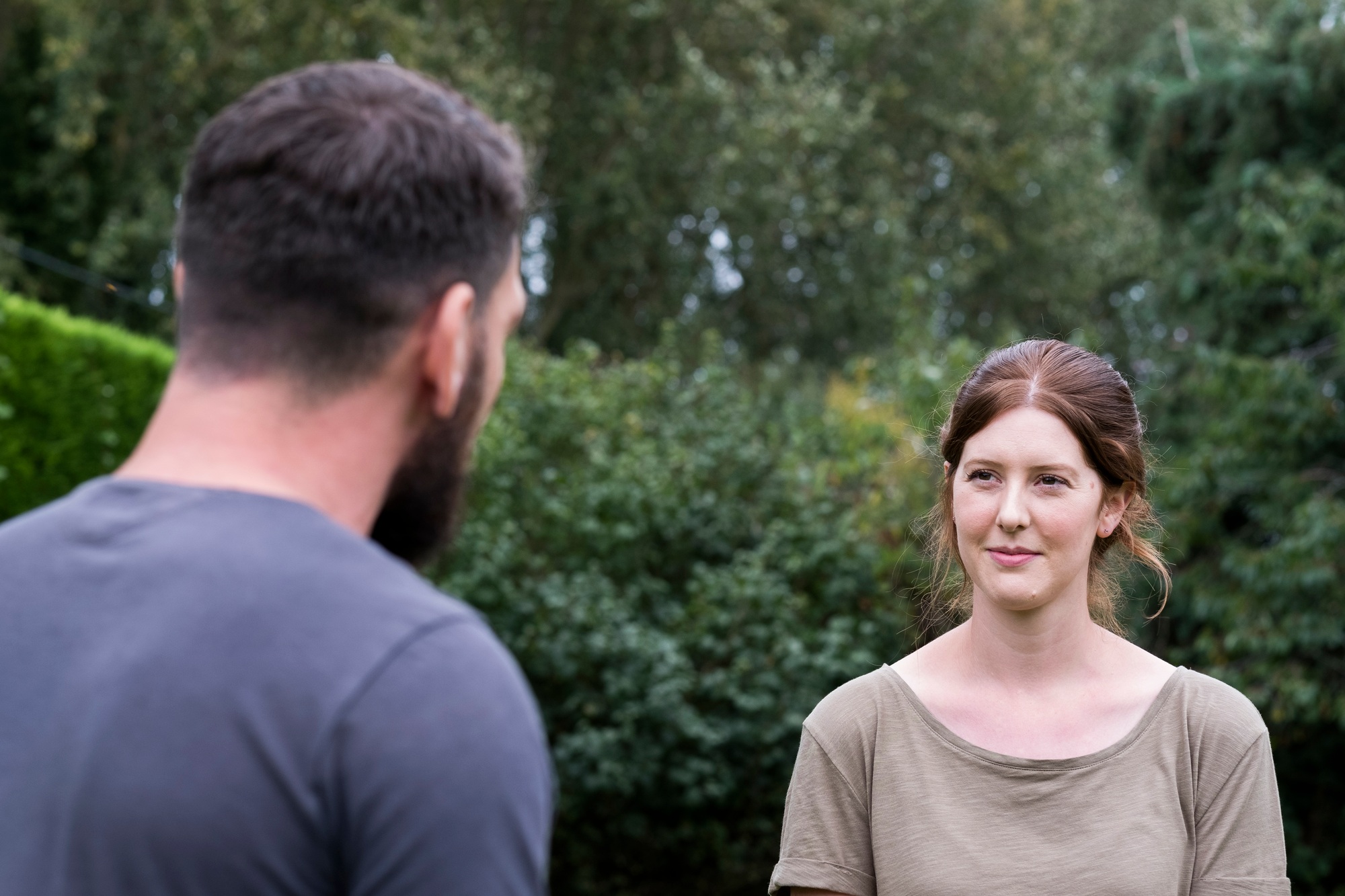 Therapist and client talking in a garden, man and woman