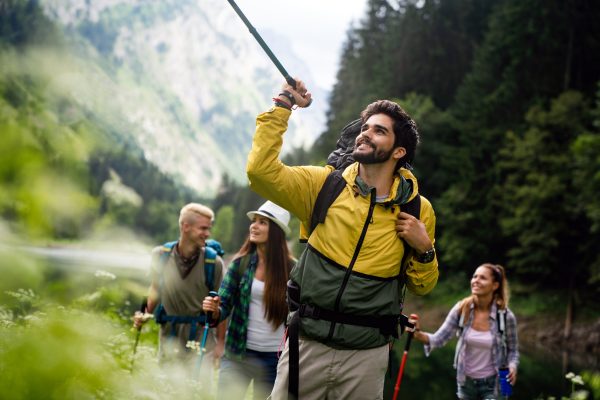 Group of happy fit friends hiking, trekking together outdoor nature Group of happy fit friends hiking, trekking together outdoor nature